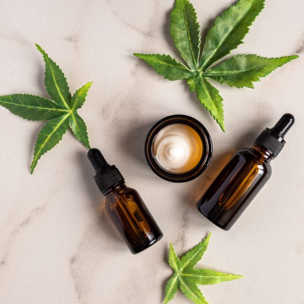 top-view-of-cannabis-face-serum-and-cream-or-oil-dropper-concept top-view-of-cannabis-face-serum-and-cream-or-oil-dropper-concept